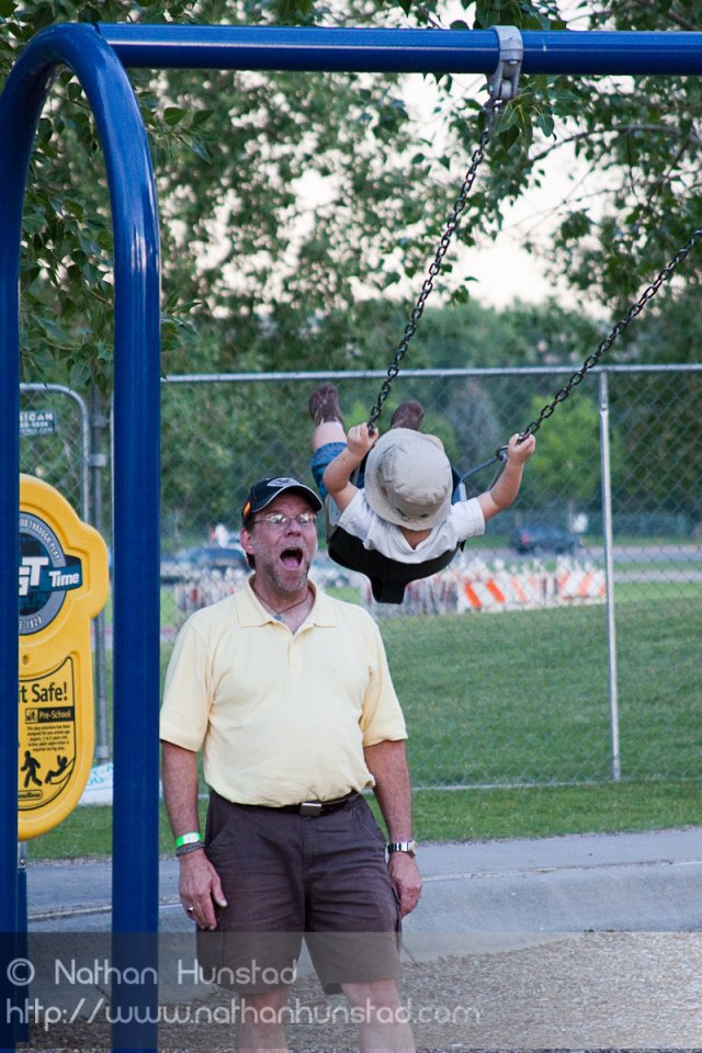 John Miller and Michael Weber playing on the swings at the Colorado Irish Festival